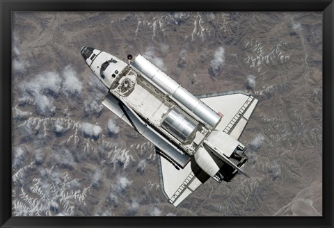 Framed Aerial view of Space Shuttle Discovery over Earth as it approaches the International Space Station Print