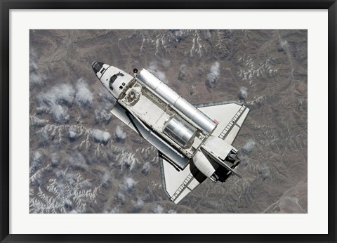 Framed Aerial view of Space Shuttle Discovery over Earth as it approaches the International Space Station Print