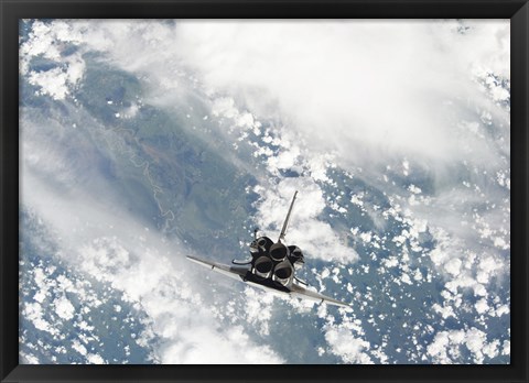 Framed Rear view of the Three main Engines of Space Shuttle Discovery as the Shuttle approaches the International Space Station Print