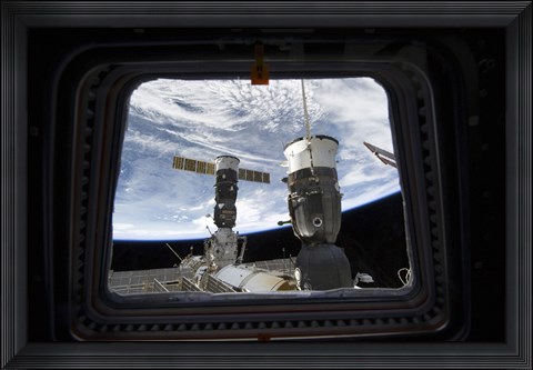 Framed Two Russian Spacecraft Docked with the International Space Station, as seen from Space Shuttle Discovery&#39;s Flight Deck Window Print
