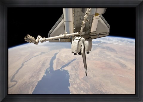 Framed Aft Section of the Docked Space Shuttle Discovery and the Station&#39;s Robotic Canadarm2 Print