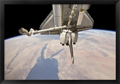 Framed Aft Section of the Docked Space Shuttle Discovery and the Station&#39;s Robotic Canadarm2 Print