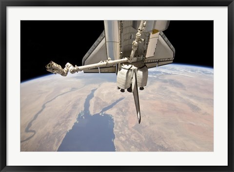 Framed Aft Section of the Docked Space Shuttle Discovery and the Station&#39;s Robotic Canadarm2 Print