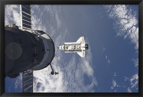 Framed Space Shuttle Atlantis and a Russian Spacecraft backdropped by a Blue and White Earth Print
