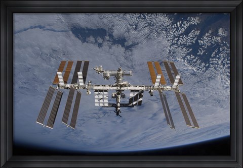 Framed International Space Station set against the background of a cloud covered Earth Print