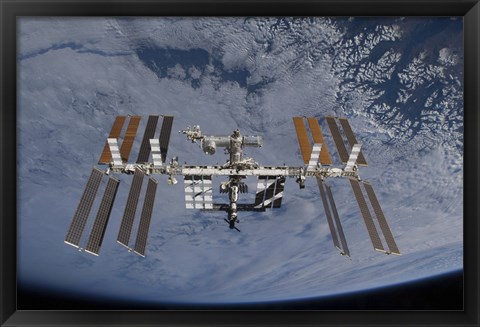 Framed International Space Station set against the background of a cloud covered Earth Print