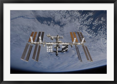 Framed International Space Station set against the background of a cloud covered Earth Print