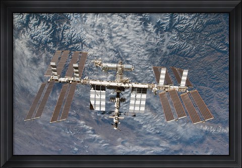 Framed International Space Station Backdropped by a Rugged Earth Terrain Print
