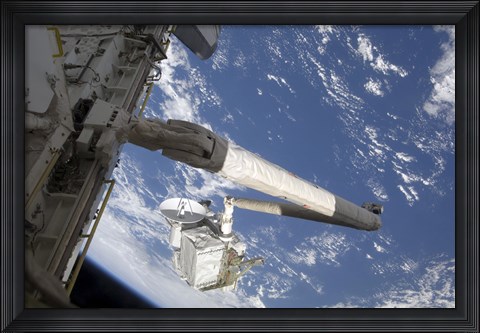 Framed Integrated Cargo Carrier in the grasp of the shuttle&#39;s remote manipulator system arm Print