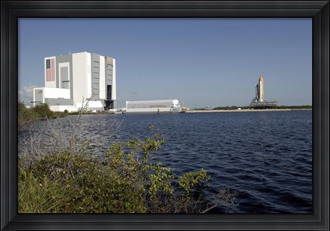Framed Viewed across the Basin, Space Shuttle Atlantis Crawls Toward the Launch Pad Print