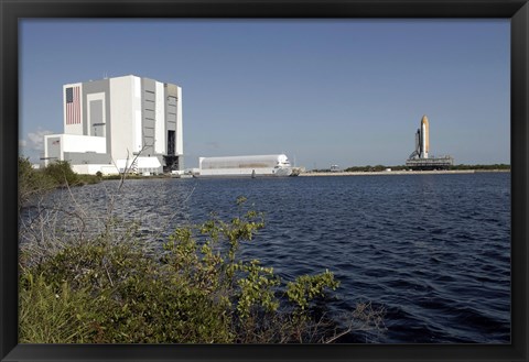 Framed Viewed across the Basin, Space Shuttle Atlantis Crawls Toward the Launch Pad Print