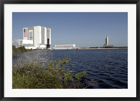 Framed Viewed across the Basin, Space Shuttle Atlantis Crawls Toward the Launch Pad Print