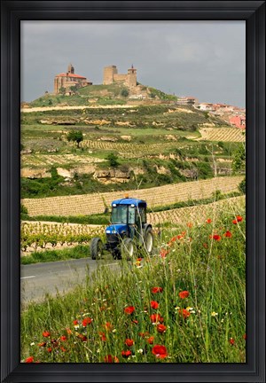 Framed Blue tractor on rural road, San Vicente de la Sonsierra Village, La Rioja, Spain Print