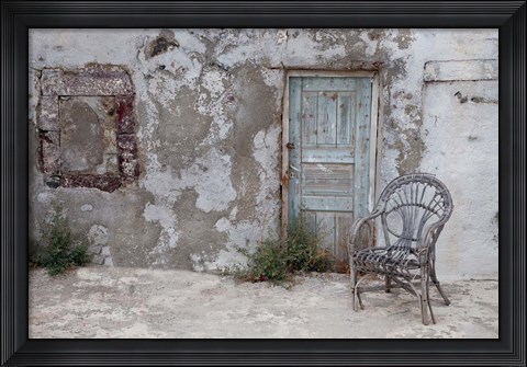 Framed Old Building chair and doorway in town of Oia, Santorini, Greece Print