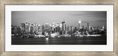 Framed Skyscrapers lit up at night in a city, Manhattan, NY Print