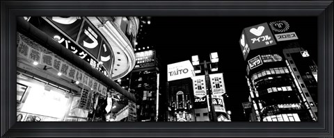 Framed Low angle view of buildings lit up at night, Tokyo, Japan Print