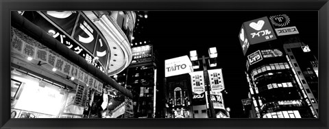 Framed Low angle view of buildings lit up at night, Tokyo, Japan Print