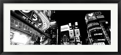 Framed Low angle view of buildings lit up at night, Tokyo, Japan Print