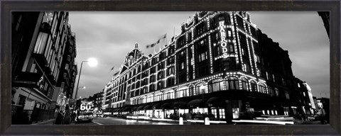 Framed Low angle view of buildings lit up at night, Harrods, London, England BW Print