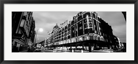 Framed Low angle view of buildings lit up at night, Harrods, London, England BW Print