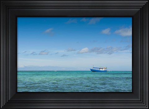 Framed Fishing boat in the turquoise waters of the blue lagoon, Yasawa, Fiji, South Pacific Print
