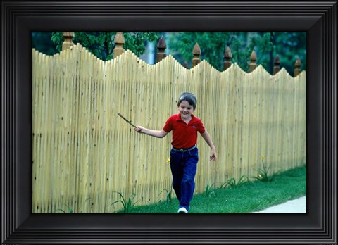 Framed 1980s Smiling Boy Running Along Sidewalk Print