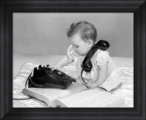 Framed 1960s Baby Girl With Telephone Book Print