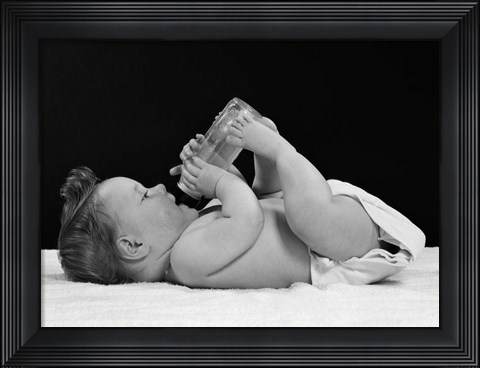 Framed 1950s Baby Lying On Back Drinking From Bottle Print