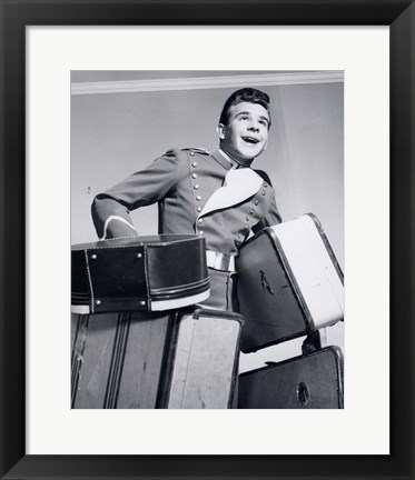 Framed 1950s Smiling Bellboy Carrying Four Bags Of Luggage Print