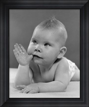 Framed 1950s Baby Lying On Stomach With Thumb In Mouth Print