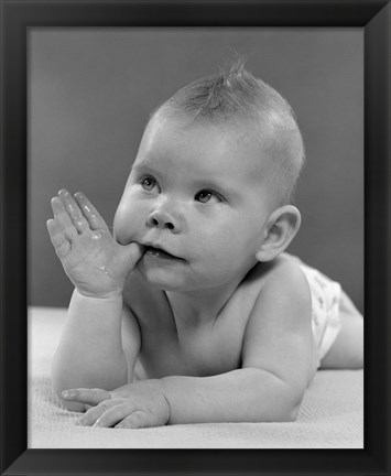 Framed 1950s Baby Lying On Stomach With Thumb In Mouth Print