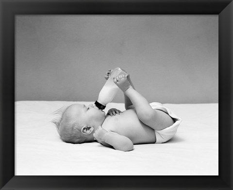 Framed 1940s Baby Prone Drinking From Milk Bottle Print