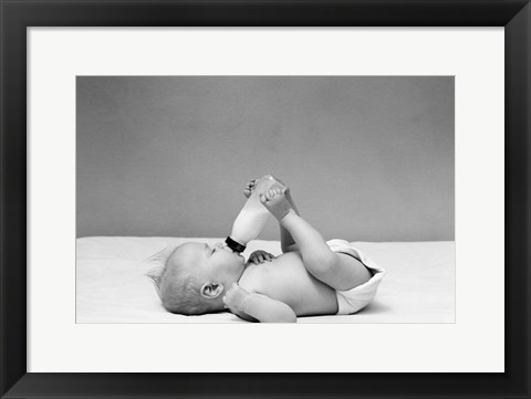 Framed 1940s Baby Prone Drinking From Milk Bottle Print