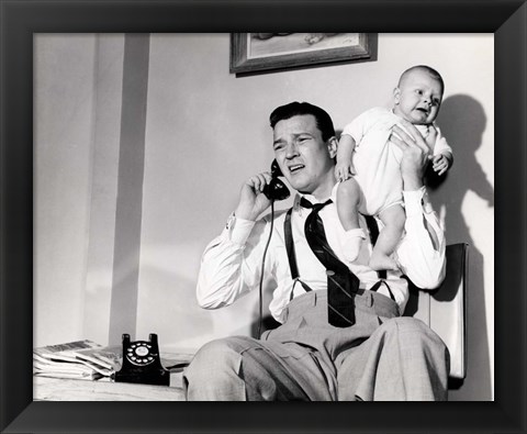 Framed 1950s Father Holding Baby While On The Phone Print