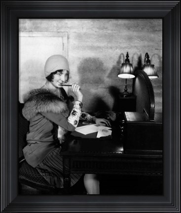 Framed 1920s  Woman With Pen To Lips Wearing Cloche Hat Print