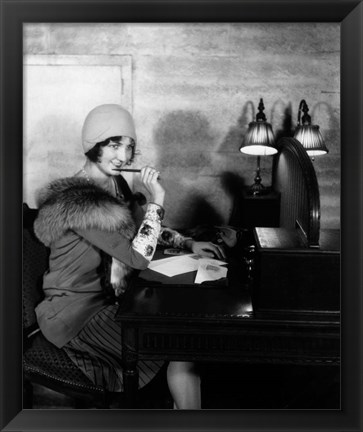 Framed 1920s  Woman With Pen To Lips Wearing Cloche Hat Print