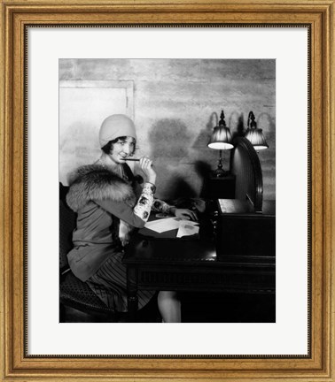 Framed 1920s  Woman With Pen To Lips Wearing Cloche Hat Print