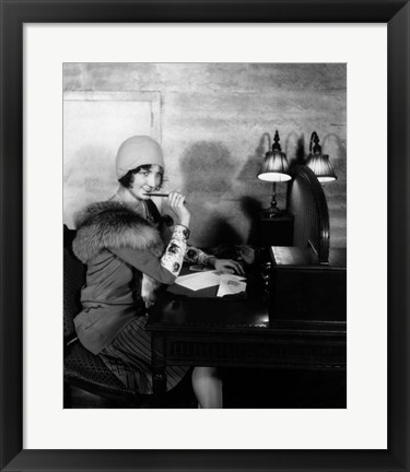 Framed 1920s  Woman With Pen To Lips Wearing Cloche Hat Print