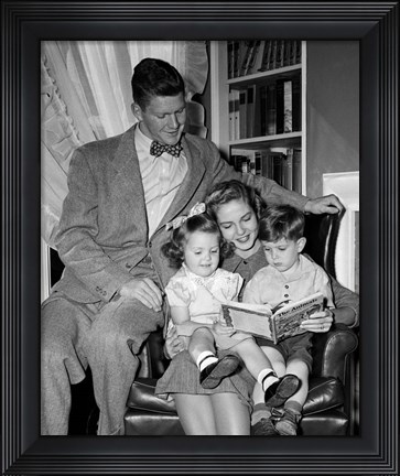 Framed 1940s Father Watching  Mother Reading To Son And Daughter Print